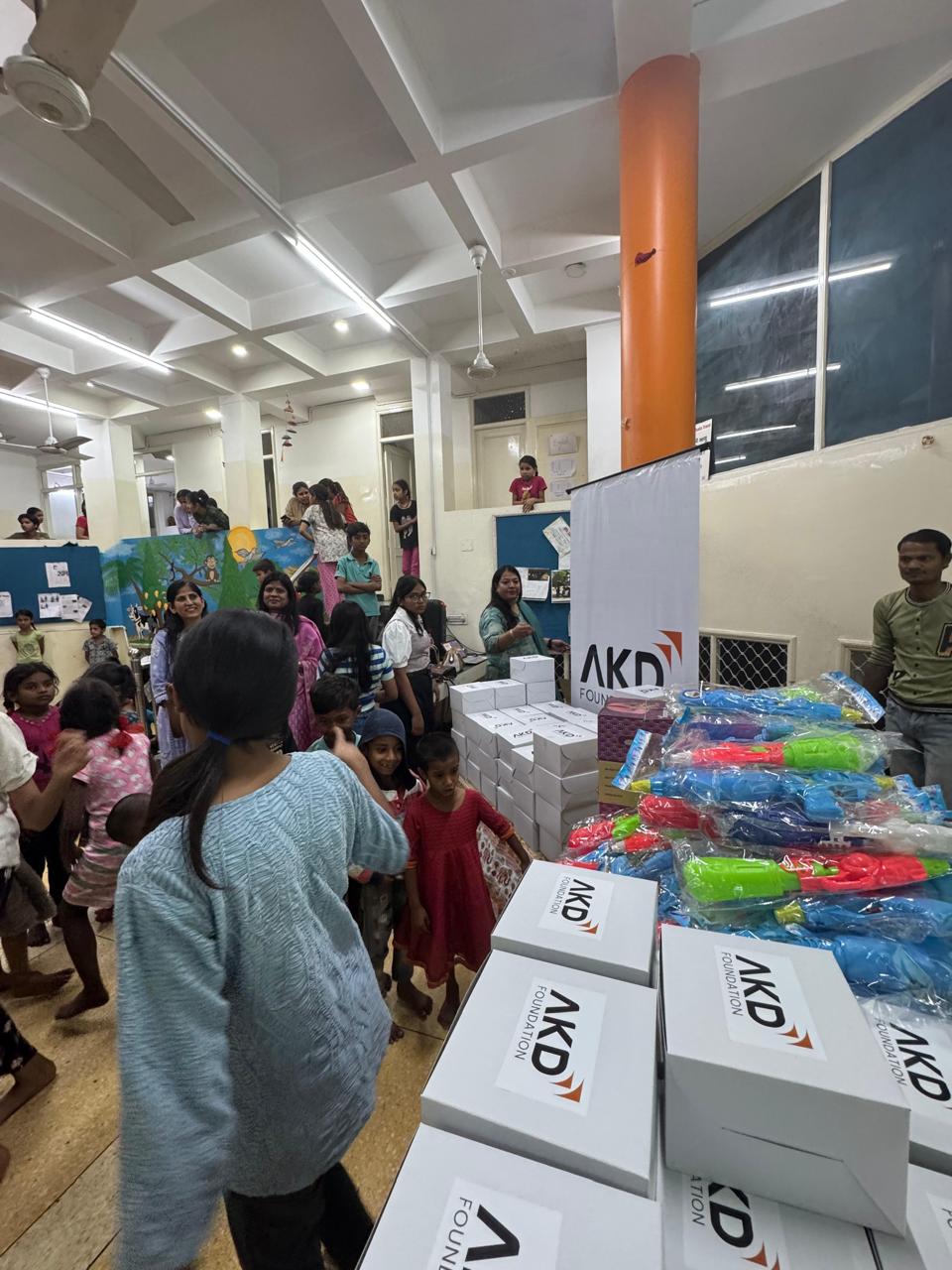 AKD Foundation — gift distribution event with children